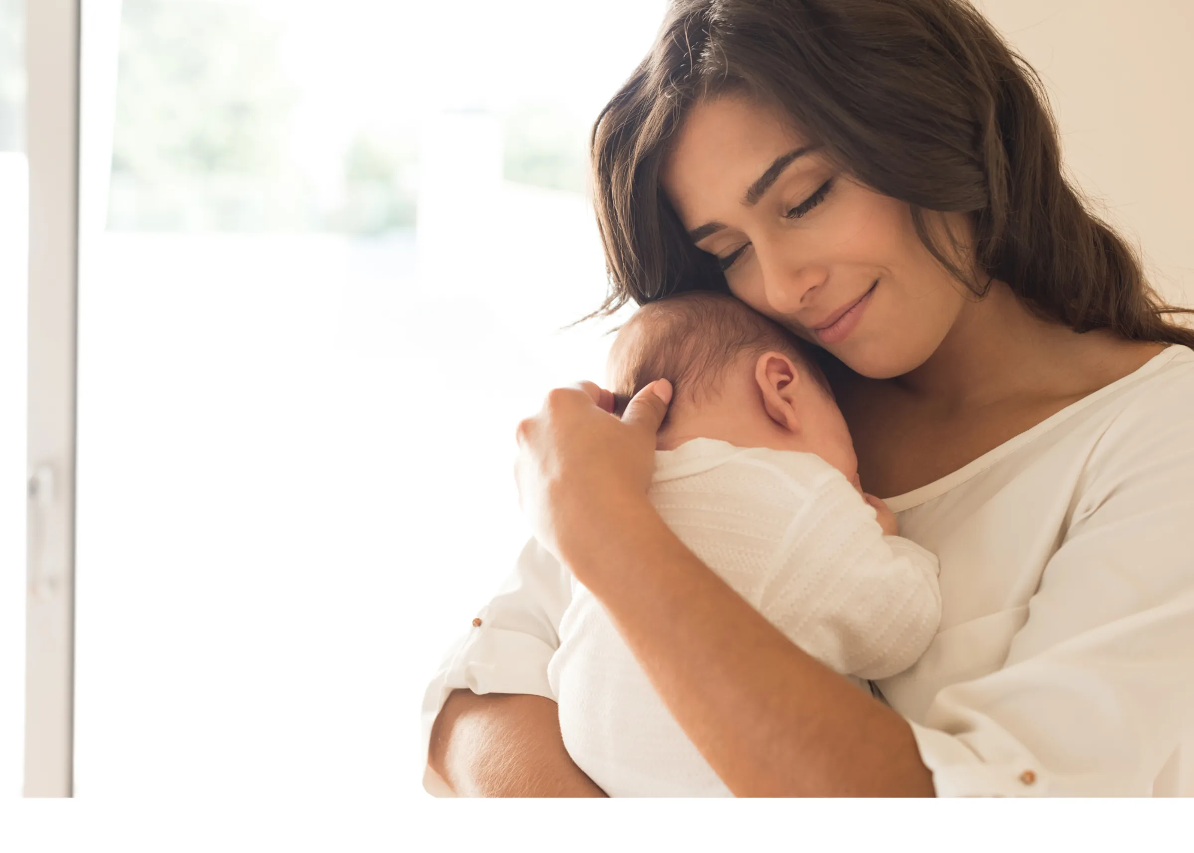 Mother holding her sleeping newborn close to her chest
